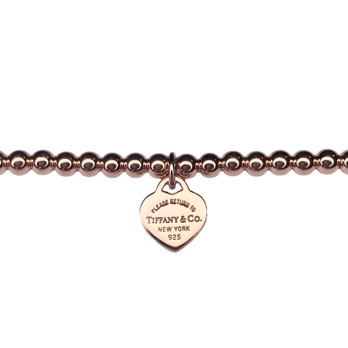 Tiffany & Co. heart pendant on a  unbranded ball bracelet in roségold