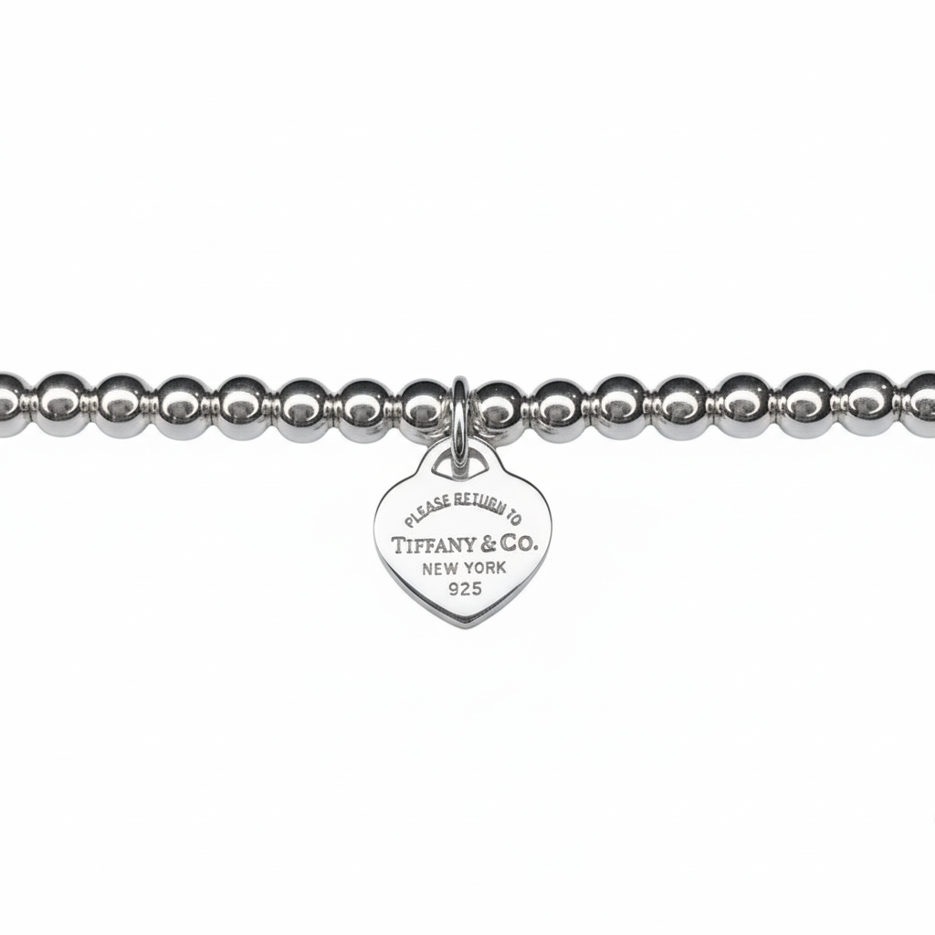 Tiffany & Co. bracelet ( Tiffany heart pendant on unbranded ball bracelet)