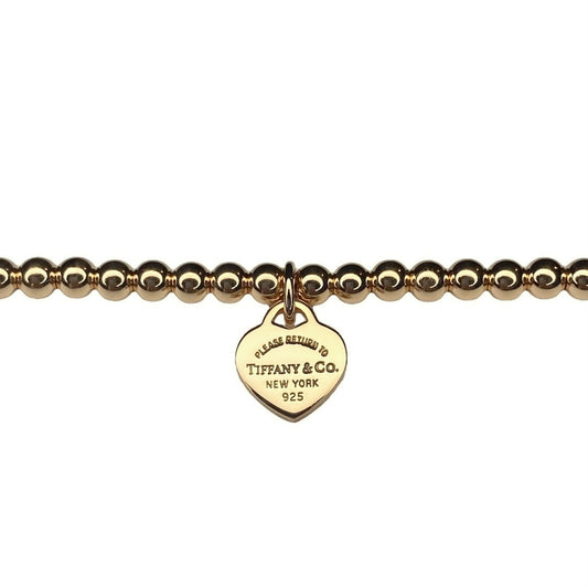 Tiffany & Co. bracelet (Tiffany heart pendant on unbranded ball bracelet) in gold