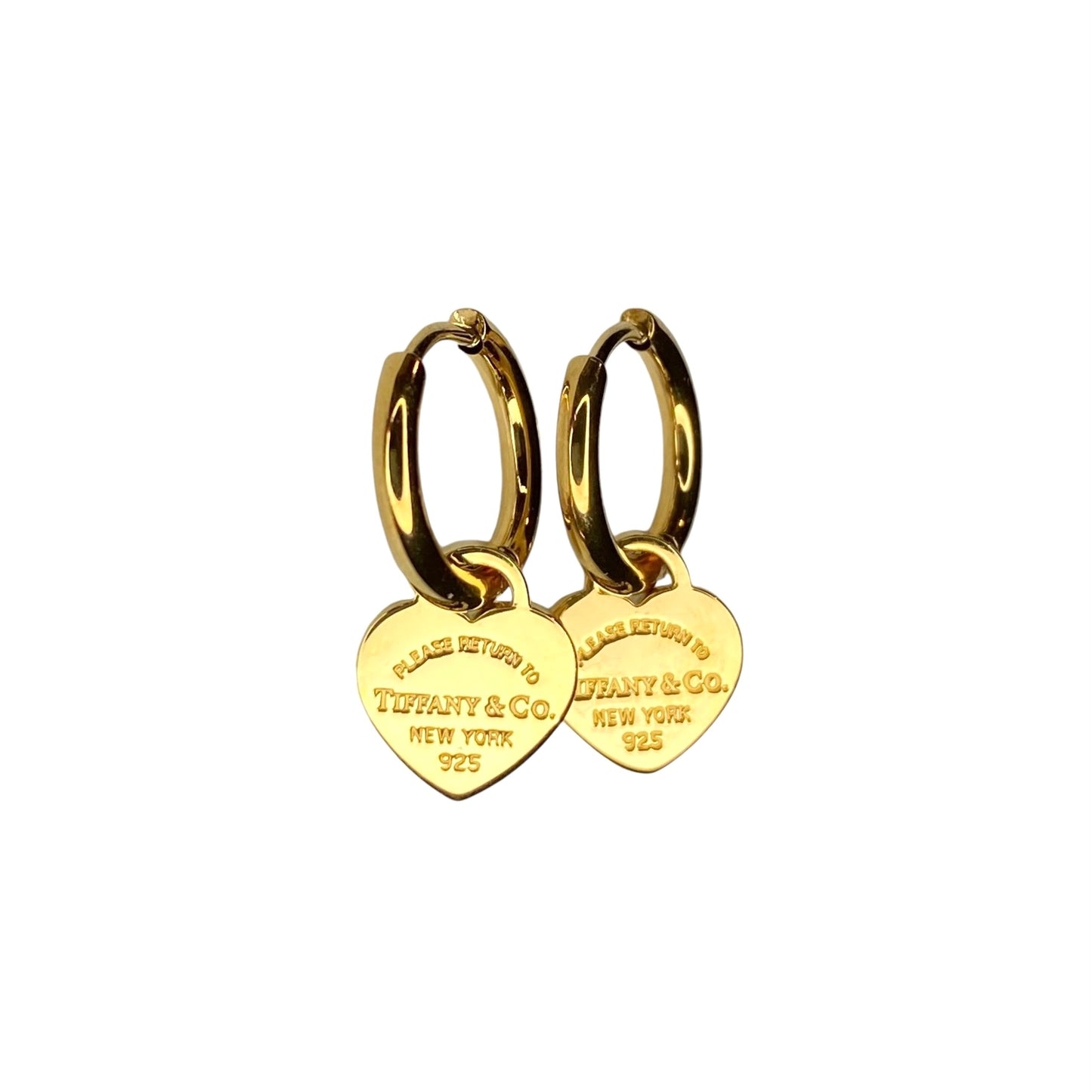 Tiffany & Co. gold heart pendant on unbranded earrings
