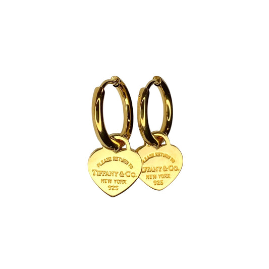 Tiffany & Co. gold heart pendant on unbranded earrings