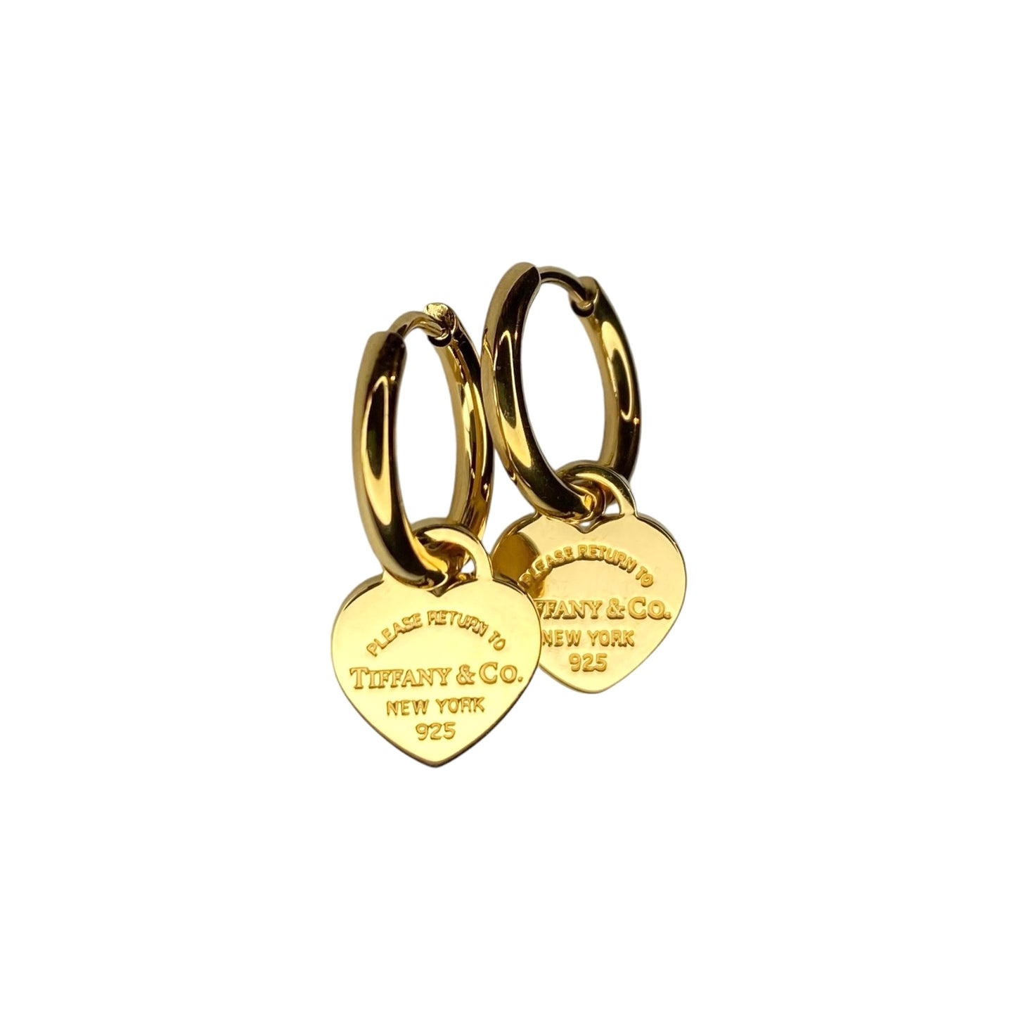 Tiffany & Co. gold heart pendant on unbranded earrings