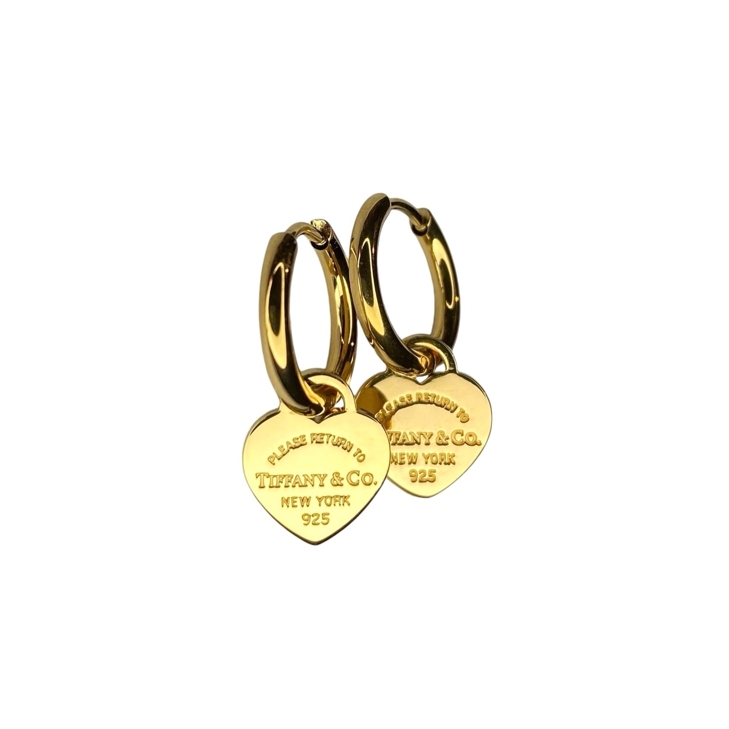 Tiffany & Co. gold heart pendant on unbranded earrings