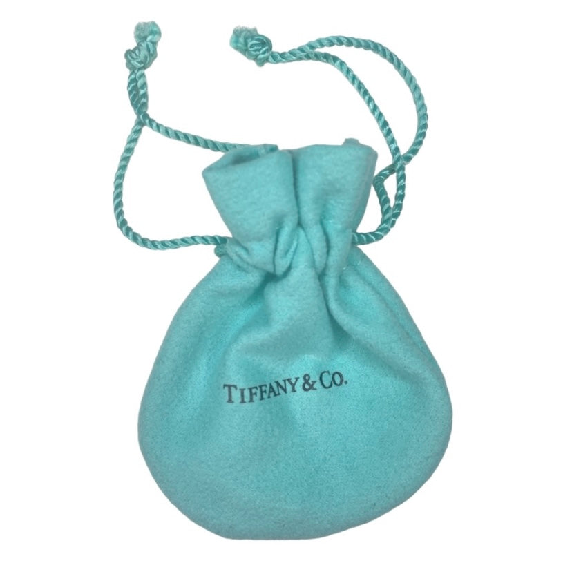 Tiffany & Co. gold heart pendant on unbranded earrings