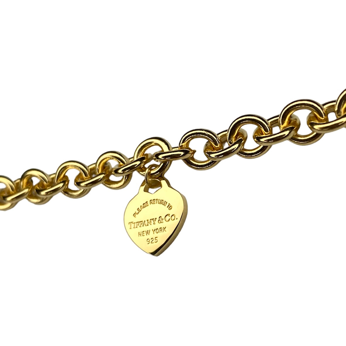 Tiffany & Co. gold heart pendant on an unbranded link bracelet, adjustable